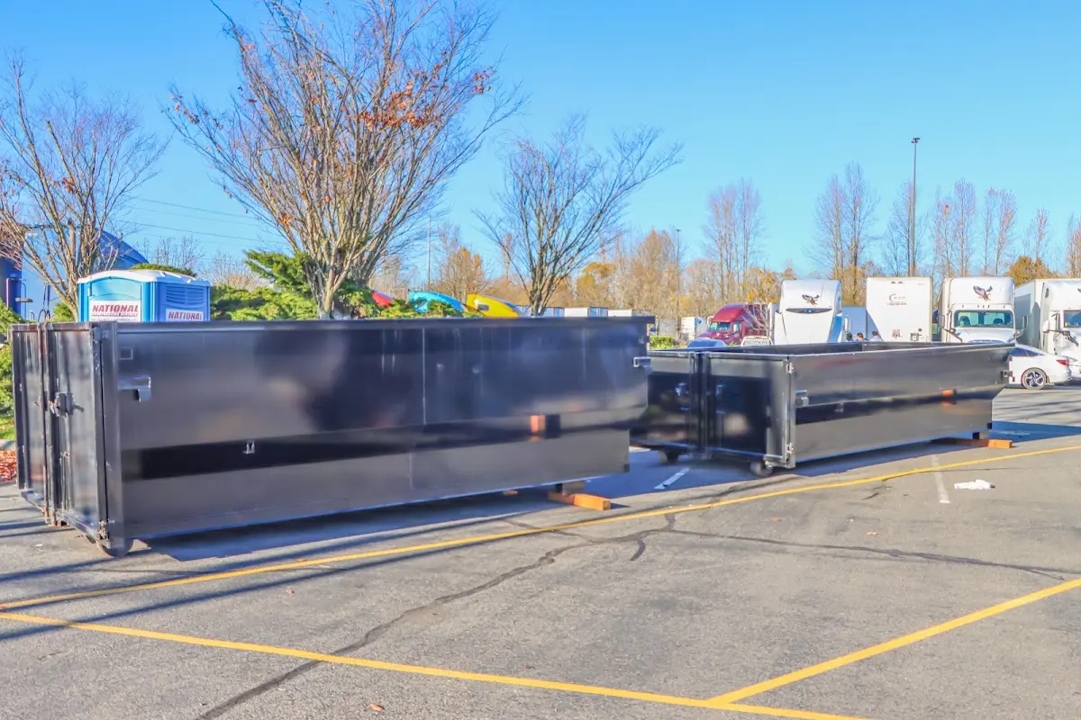 Professional dumpster rental service with roll-off container on residential driveway in Fishkill